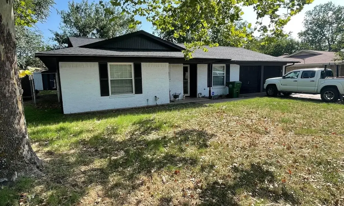 Professional roofing crew working on a residential roof in Freehold
